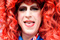drag queen with head of red curls